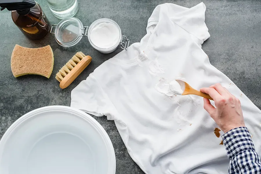 Laundry Stain Removal Guide: Pre-treating stains on clothing with natural cleaning agents like baking soda.